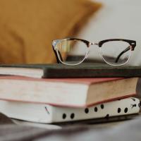 Glasses on top of books