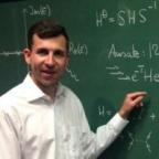 Thomas Jagau standing in front of a chalkboard.