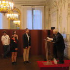 Prof. Thomas Jagau standing in front of a podium receiving the award